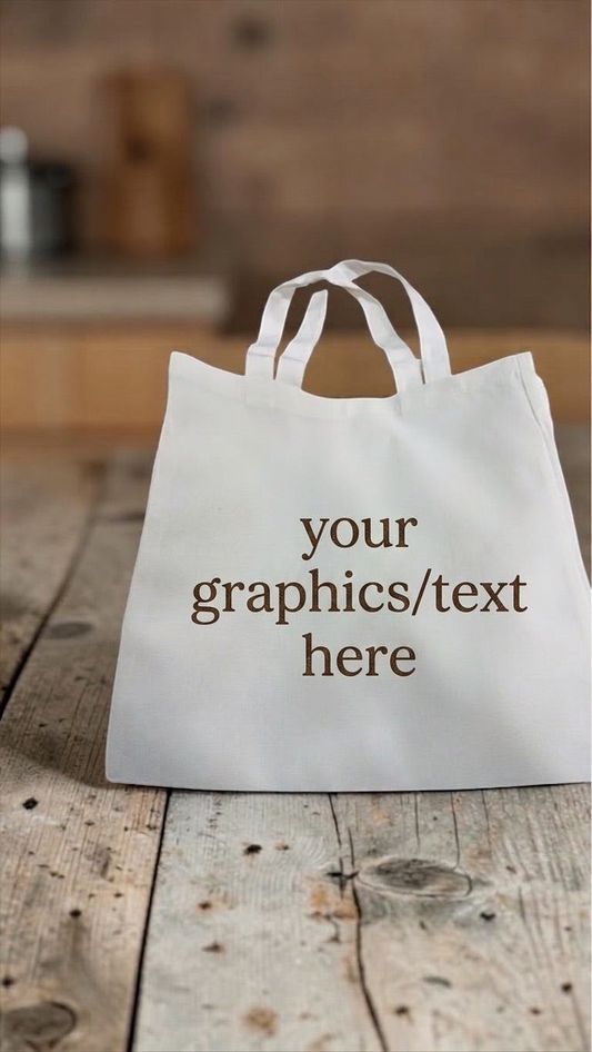nkhandcraftedgifts white polyester and cotton tote bag with customizable text area on a rustic wooden table